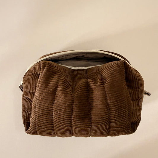 Brown corduroy bag on a beige background